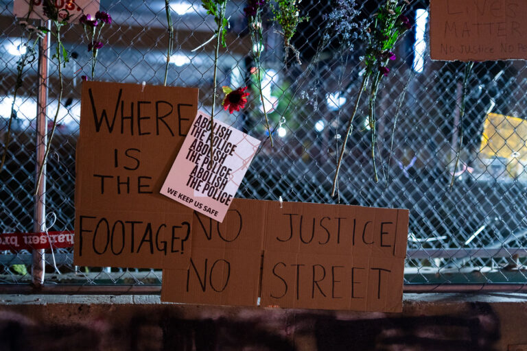Where is the footage? Winston Smith protest signs 1 Protest signs hanging on the fencing around Seven Points Mall where Winston Smith was killed by law enforcement 4 months prior.