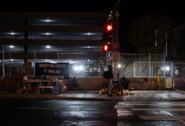 A vigil outside the parking ramp at Seven Points Mall where Winston Smith was killed 4 months prior.
