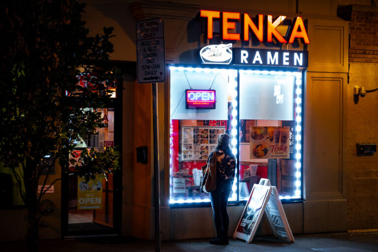 Tenka Ramen on Lake Street in Minneapolis 1 Woman looking at the menu in the window at Tenka Ramen on Lake Street in Uptown Minneapolis.
