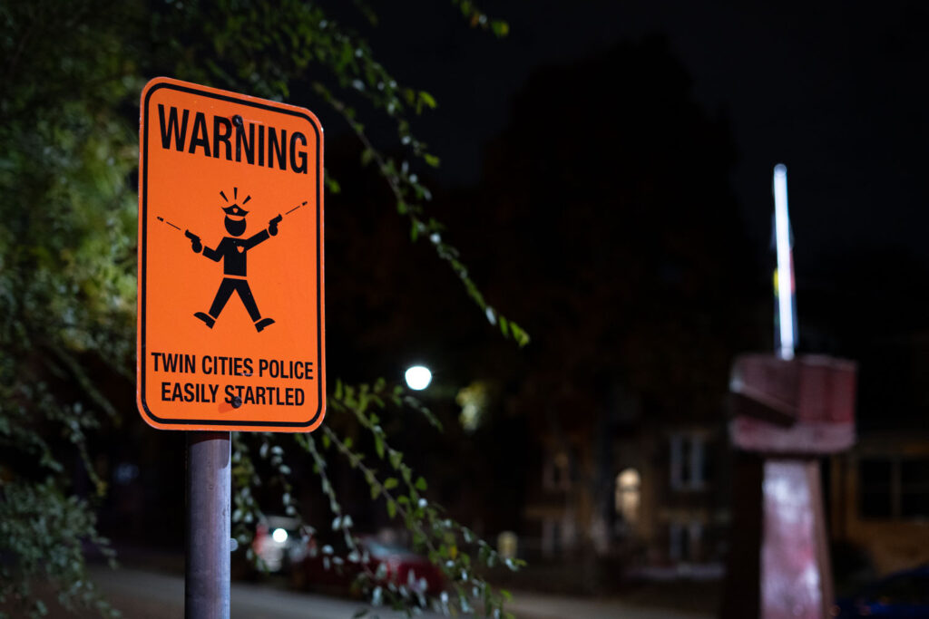 A sign reading "Warning Twin Cities Police Easily Startled" at 39th and Chicago Avenue, George Floyd Square
