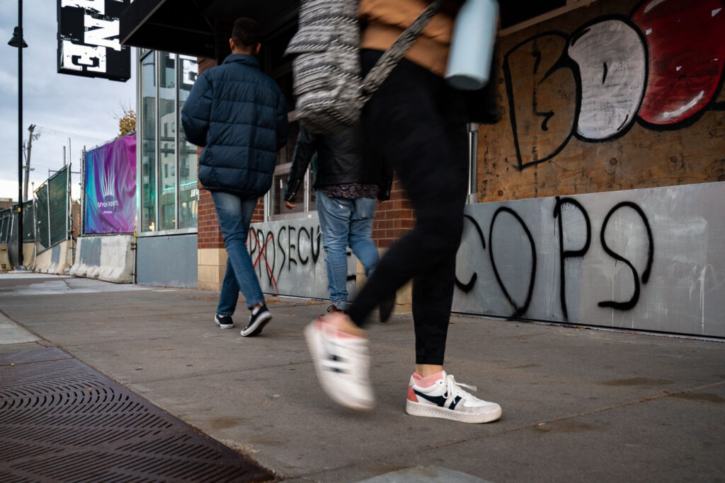 People walk past Seven Points mall in Uptown Minneapolis the day before the election.