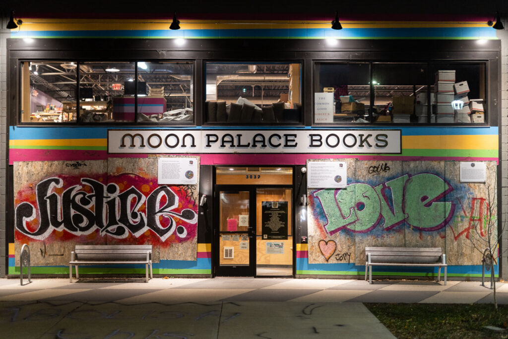 The "Abolish The Police" boards that have covered Moon Palace Books since last May have been removed. Prior to boards, a large banner of same message filled windows as they refused to allow police to stage on their property, instead setting up medic stations to treat the injured.