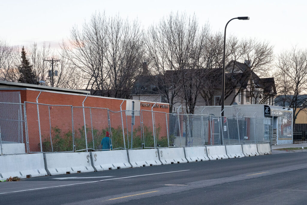The Minneapolis Police Fifth Precinct in South Minneapolis surrounded by security fencing.