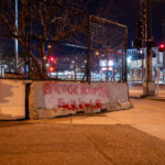 "Avenge Kenosha" and “Fuck Kyle” written on the barriers surrounding the third precinct.