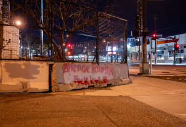 "Avenge Kenosha" and “Fuck Kyle” written on the barriers surrounding the third precinct.
