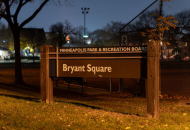 Bryant Square Park sits in the heart of the Lowry Hill East neighborhood—better known as “The Wedge”—and has been part of Minneapolis’ park system since the early 20th century. The illuminated sign marks one of the city’s older community parks, which originally grew out of residential expansion along the streetcar lines that shaped much of South Minneapolis. The park has long served as a gathering place for the surrounding blocks, offering playgrounds, athletic courts, open green space, and a recreation center that has hosted everything from youth programs to neighborhood meetings.

Historically, Bryant Square reflects the city’s early investment in small, walkable parks distributed throughout dense residential districts. Its development mirrored the Wedge’s transformation from a streetcar suburb into one of Minneapolis’ most eclectic and tightly knit urban neighborhoods, where parks continue to function as important public commons.