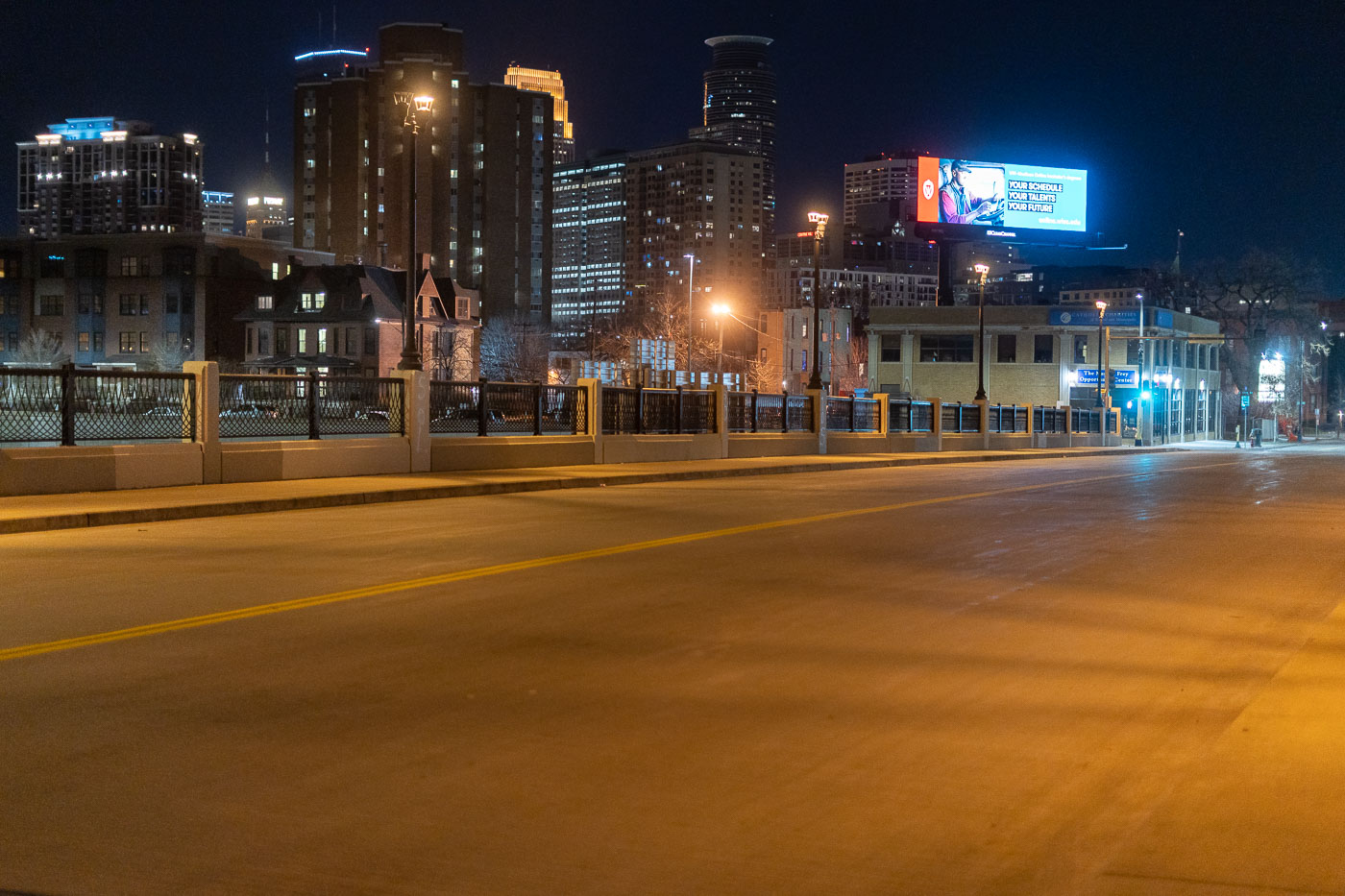 Chicago Avenue crosses Interstate 94 in Minneapolis, Minnesota, at night, with the downtown skyline visible in the background.
