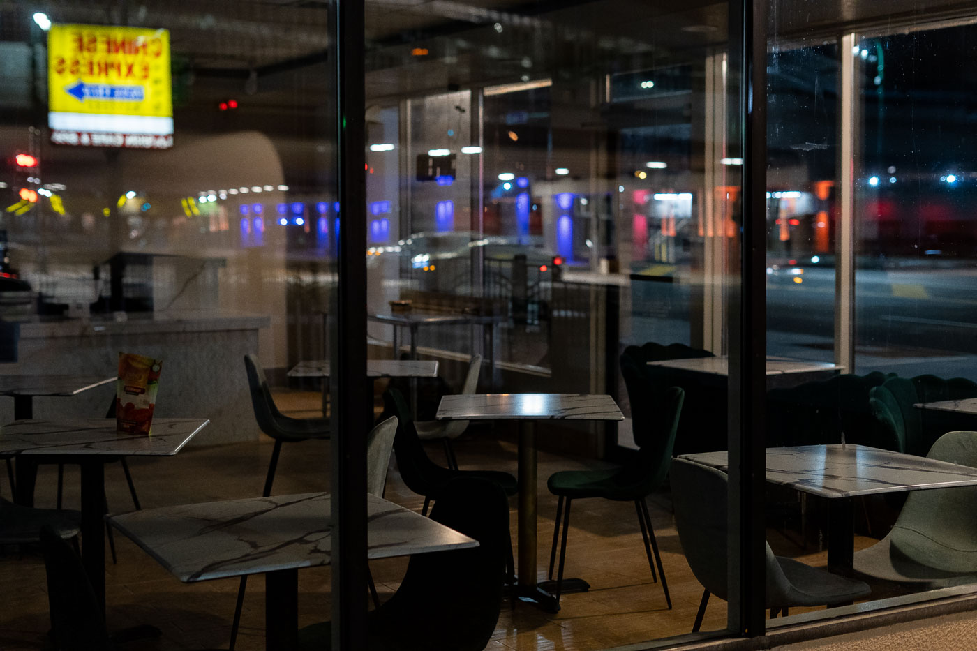 The dining room of Chinese Express restaurant on Lake Street, Minneapolis, is seen through its windows at night. The restaurant offers quick-service dining.