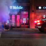 The Minneapolis Fire Department puts out garbage can fires on Lake Street the day after the election in Uptown Minneapolis.