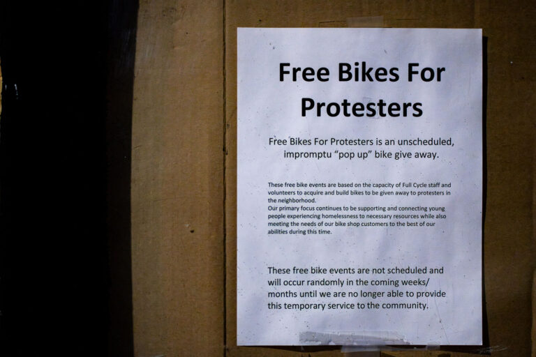 “Free Bikes for Protesters” Notice, Minneapolis 1 This handwritten notice, taped to the window of a Minneapolis bike shop, reflects one of the many grassroots mutual-aid efforts that emerged during the city’s protest movement. The shop offered free, rebuilt bicycles to anyone participating in demonstrations—an informal and unscheduled giveaway run entirely by staff and volunteers. While their primary mission focused on supporting young people experiencing homelessness, they used whatever capacity they had to meet the immediate needs of the surrounding community during a period of intense civic mobilization.The message captures a moment when local businesses and residents quickly adapted, improvising systems of care and resource-sharing amid the broader upheaval following the killing of George Floyd. These small gestures—bikes, food, first-aid kits, and other supplies—became essential infrastructure for protesters navigating the city on foot and by bike as streets closed and transit routes fluctuated.