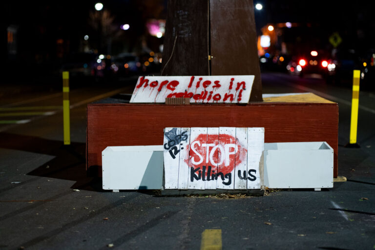 George Floyd Square: Signs Against Police Violence 1 Signs protesting police violence, including "STOP Killing Us," are displayed at George Floyd Square in Minneapolis.