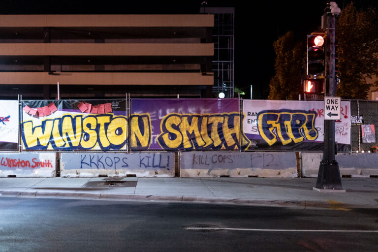Winston Smith FTP KKKops Kill 4 Winston Smith graffiti on banner surrounding the parking ramp he was killed by law enforcement in Uptown Minneapolis