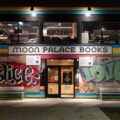 The "Abolish The Police" boards that have covered Moon Palace Books since last May have been removed. Prior to boards, a large banner of same message filled windows as they refused to allow police to stage on their property, instead setting up medic stations to treat the injured.
