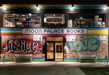 The "Abolish The Police" boards that have covered Moon Palace Books since last May have been removed. Prior to boards, a large banner of same message filled windows as they refused to allow police to stage on their property, instead setting up medic stations to treat the injured.