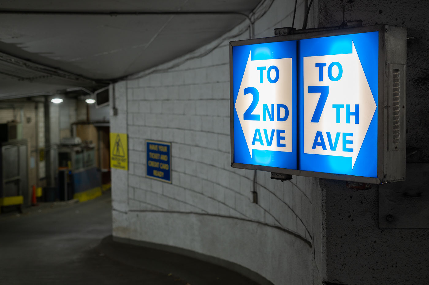 Illuminated sign in a Minneapolis parking garage directs drivers to 2nd Ave S and 7th Ave, essential urban infrastructure for downtown access.
