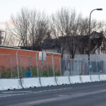 The Minneapolis Police Fifth Precinct in South Minneapolis surrounded by security fencing.