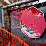 A paint covered No Trespassing sign outside the parking ramp where Winston Smith was killed by law enforcement on June 3, 2021.