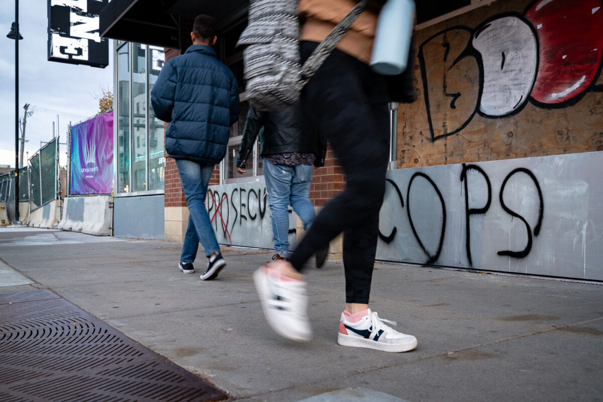 People walk past Seven Points mall in Uptown Minneapolis the day before the election.