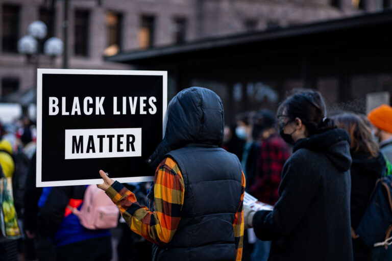 Black Lives Matter Protest at Hennepin County Government Center, Minneapolis 4 Protesters gathered outside the Hennepin County Government Center in Minneapolis, holding signs that read "Black Lives Matter." This movement, which gained national prominence in 2013, advocates for the rights and liberation of Black people. The Government Center, a significant civic building in downtown Minneapolis, has been a focal point for various public gatherings and protests, reflecting its role as a center of local governance and public discourse.