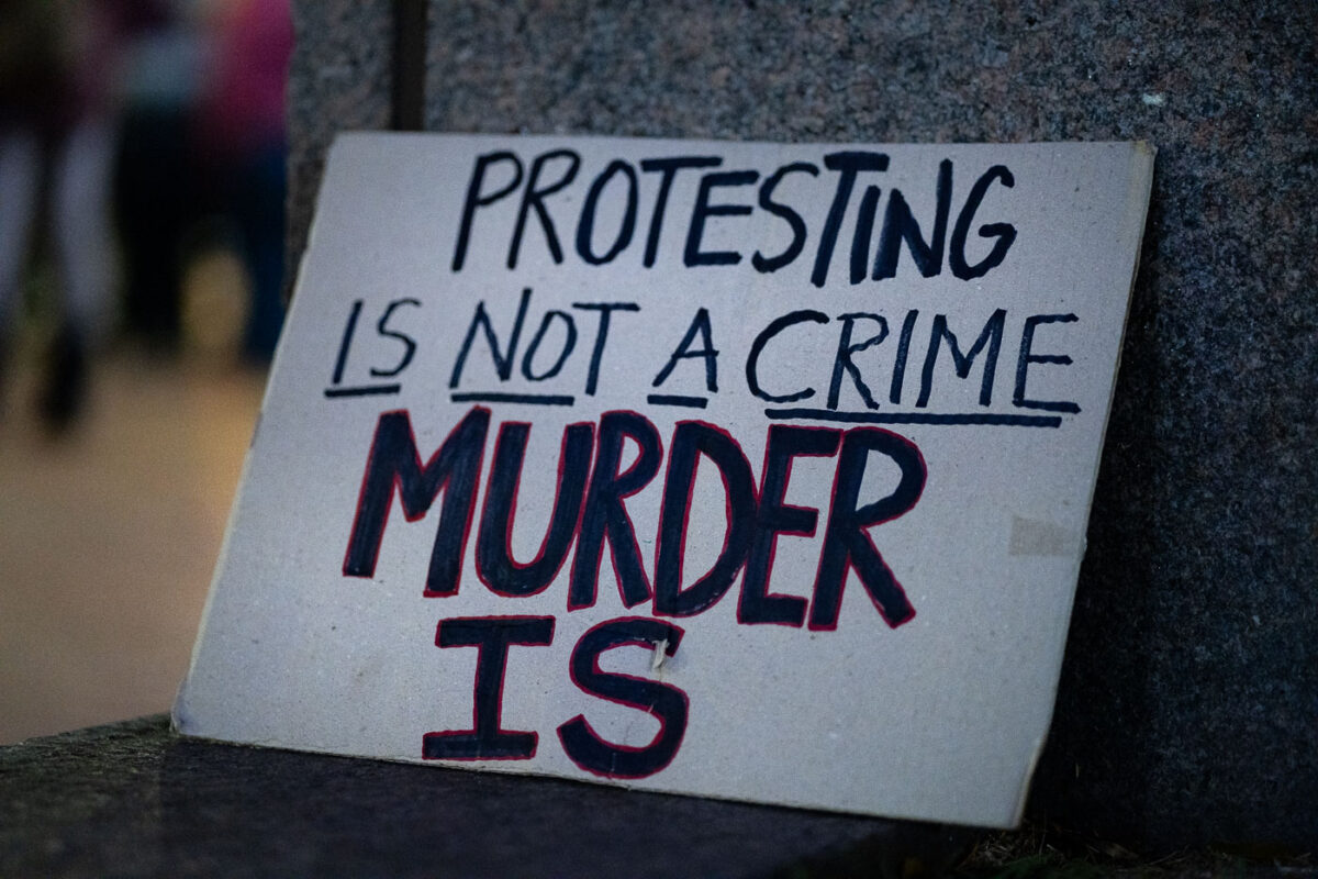 "Protesting is not a crime murder is" protest sign seen in Downtown Minneapolis