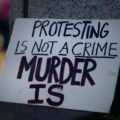 "Protesting is not a crime murder is" protest sign seen in Downtown Minneapolis