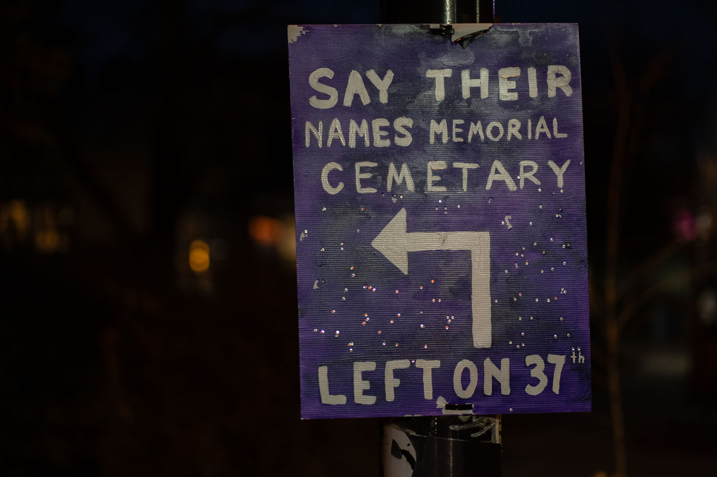 Sign for Say Their Names Memorial Cemetery, directing visitors left on 37th, in Minneapolis, Minnesota.
