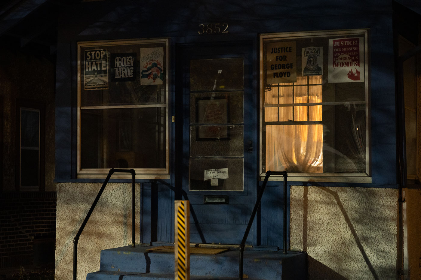 South Minneapolis home at 3852 displays protest signs in windows, including 'Justice for George Floyd,' 'Abolish the Police,' and 'Justice for Missing and Murdered Indigenous Women.'