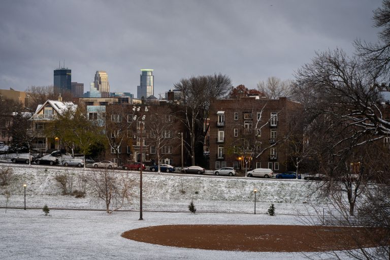 Stairs at Powderhorn Park, Minneapolis: First Snowfall Morning 2 Powderhorn Park in Minneapolis on a snowy morning, with apartment buildings and the downtown skyline visible in the distance.