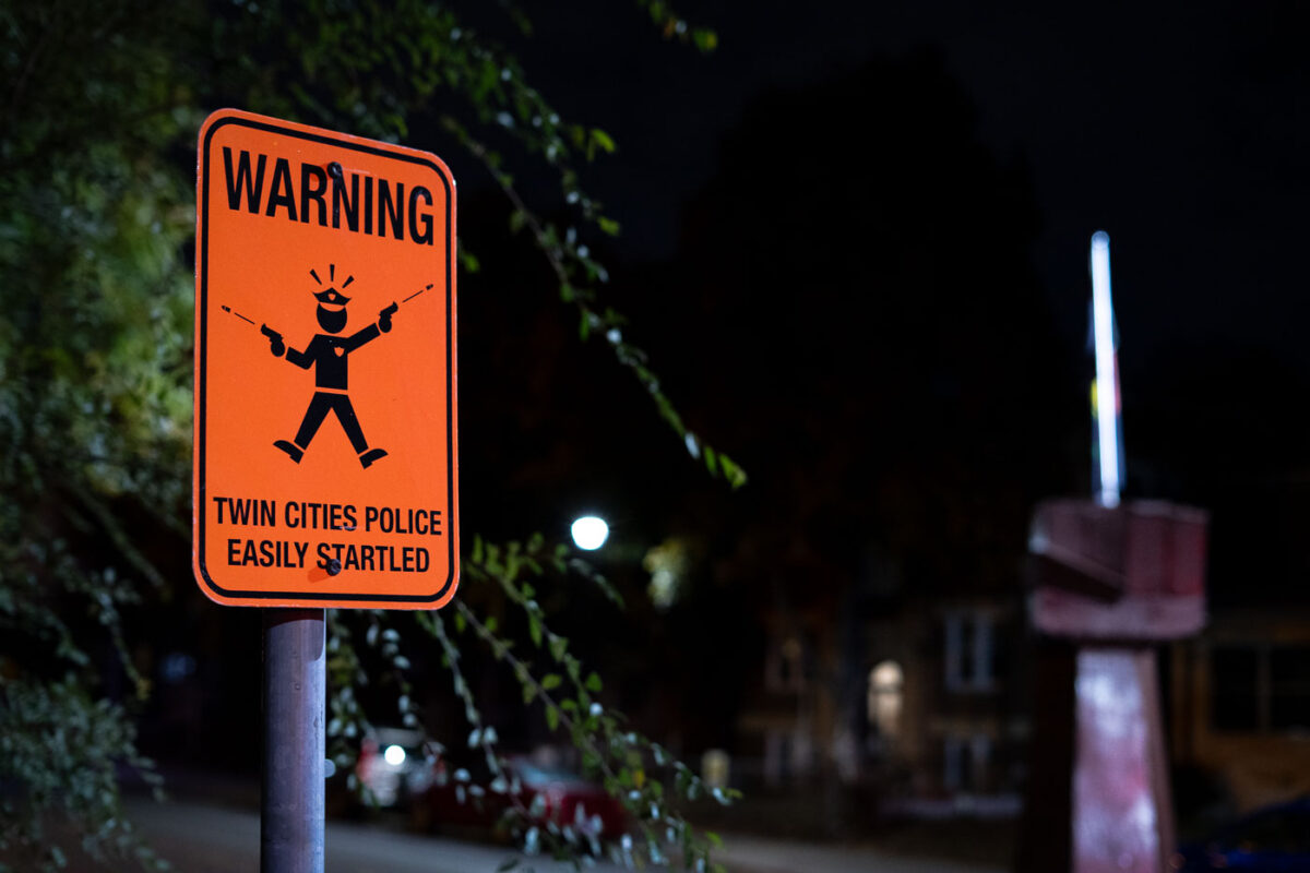 A sign reading "Warning Twin Cities Police Easily Startled" at 39th and Chicago Avenue, George Floyd Square.