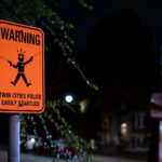 A sign reading "Warning Twin Cities Police Easily Startled" at 39th and Chicago Avenue, George Floyd Square.