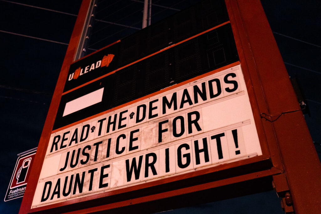 Read the demands - Justice for Daunte Wright! written on the sign at People's Way at George Floyd Square.