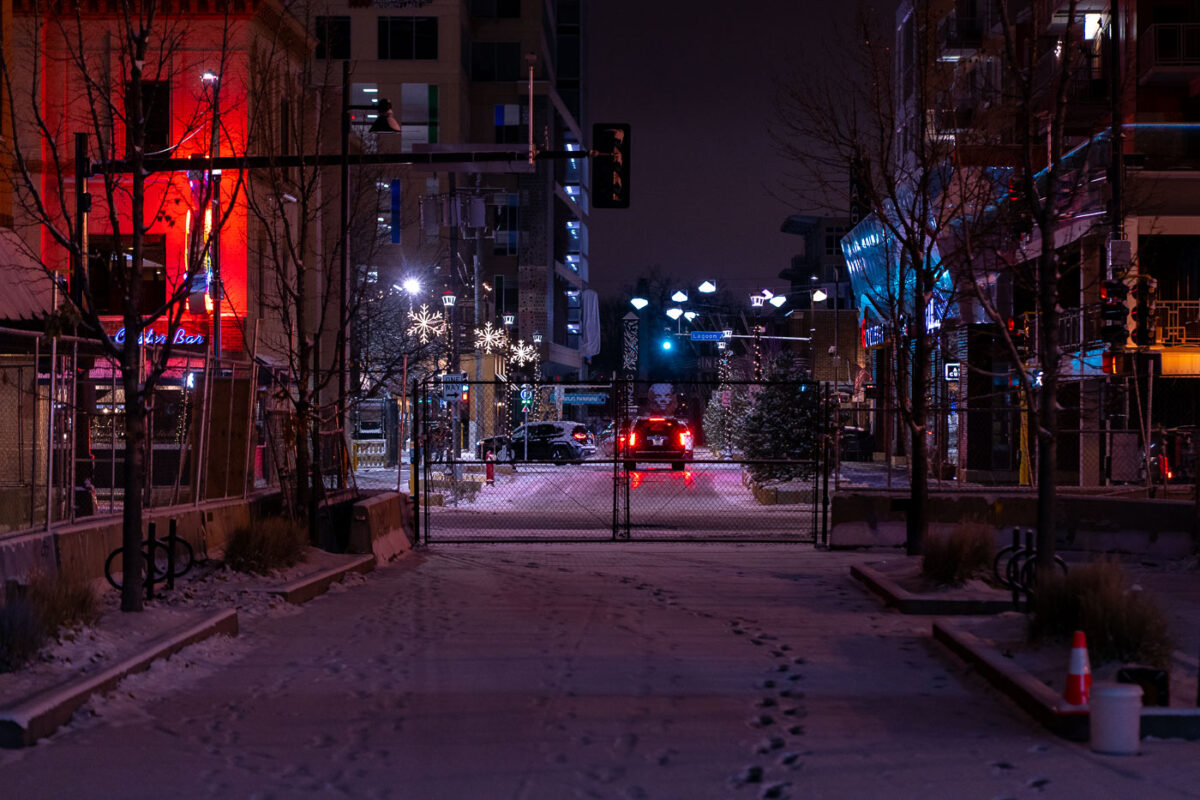 Fresh snow covers the private drive next to the Seven Points parking ramp. The area fenced off after protests over the law enforcement killing of Winston Smith on June 3rd, 2021.