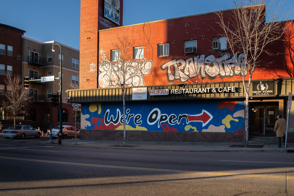Boards painted "We're Open" on Hufan Restaurant & Cafe on Lake Street.