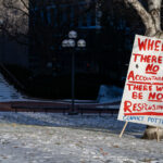 Outside the courthouse while the jury deliberates in the Kim Potter trial. Sign reading “Where there is no accountability there will be no responsibility. Convict Potter”.