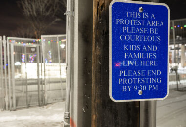 A sign placed outside the Brooklyn Center Police Department asking protests to finish by 9:30pm.
