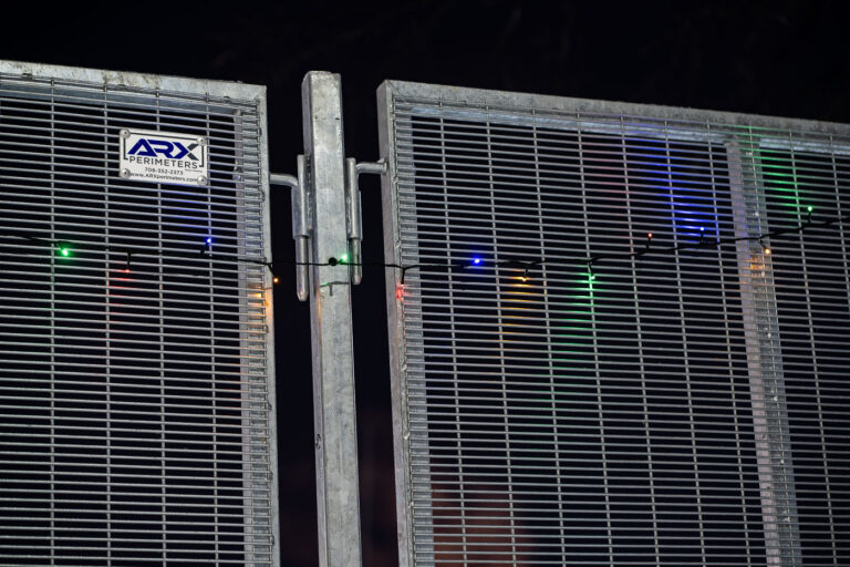 ARX Perimeter fencing with christmas lights 4 Holiday lights hanging on the ARX Perimeters fencing that surround the Brooklyn Center police station. The fencing surrounds the facility after the shooting death of Daunte Wright in April.