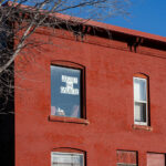 A sign reading "Justice for Daunte" hangs in a window of an apartment building in Minneapolis.