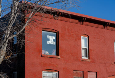 A sign reading "Justice for Daunte" hangs in a window of an apartment building in Minneapolis.