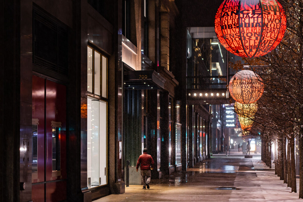 Man walks down a snowy Nicollet Mall