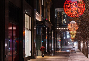 A man walks down Nicollet Mall during an early December snowfall.