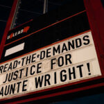 Sign on the People’s Way sign at George Floyd Square that reads "Read the demands! Justice for Daunte Wright!"