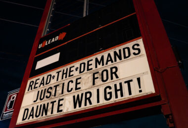 Sign on the People’s Way sign at George Floyd Square that reads "Read the demands! Justice for Daunte Wright!"