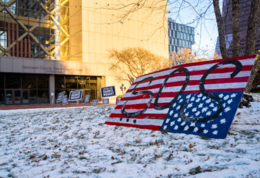 Justice for Daunte Wright signs outside the Hennepin County Government Center where Kim Potter is being tried for her involvement in his killing.