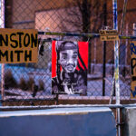 Protest signs hang on fencing outside the Lake & Girard parking ramp. The day prior was 6 months from the day Winston Smith was killed by a Federal Marshal task force.