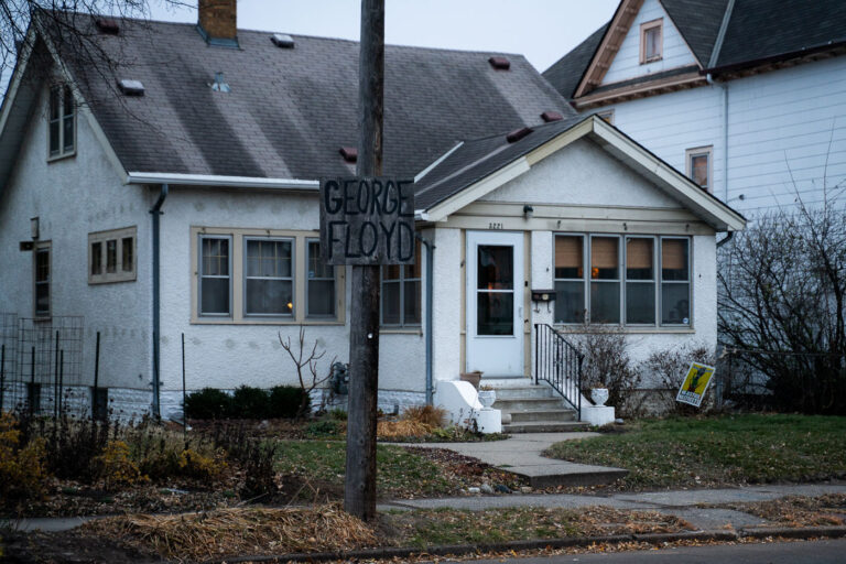 Wooden George Floyd sign in South Minneapolis 1 A George Floyd sign hangs on a street pole in South Minneapolis. A yard sign reading "No Justice No Streets" in the yard.