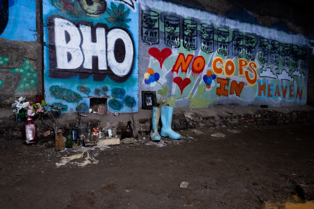 A memorial for a local activist with "no cops in heaven" painted on the walls.