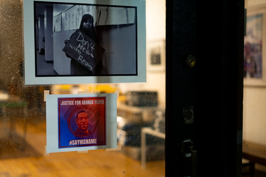 Photos on the window of a art gallery inside George Floyd Square.