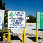A sign for AA Belize at Boca Del Rio Public Beach