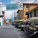 A sign reading "Don't Hesitate Vaccinate!" in San Pedro, Belize.