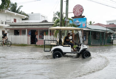 A golf cart is driven in a San Pedro rain storm.